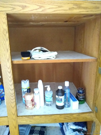 Contents of small main floor bathroom including hamper, cleaning supplies, linens, scale, hair