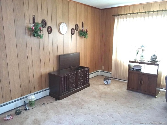 Everything in living room including carpet cleaner or steamer, vintage record cabinet, desk and