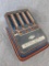 Vintage stamped steel Wolverine Adding Machine was made in the USA. All four rows and numbers