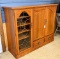 Broyhill display cabinet with hide away doors. The cabinet measures approx 57