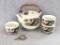 Oriental tea pot with three mugs, plus a loose tea infuser with base. Light crazing throughout. Set