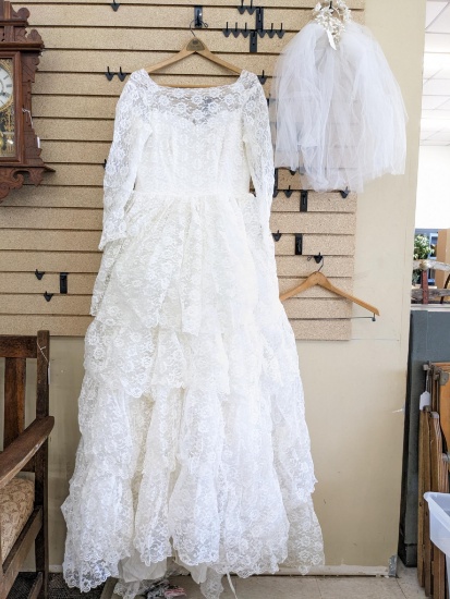 Custom lace tulle layered wedding dress and veil. Dress has some beaded embellishments on the top