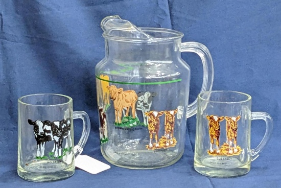 Land O Lakes pitcher with cows includes 2 of the mugs to match; pitcher measures 9-1/2" tall.