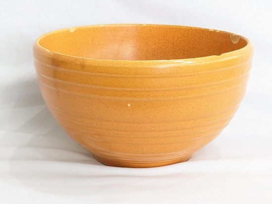 Large McCoy ribbed mixing bowl; measures 10" x 6". Does have a few chips along rim.