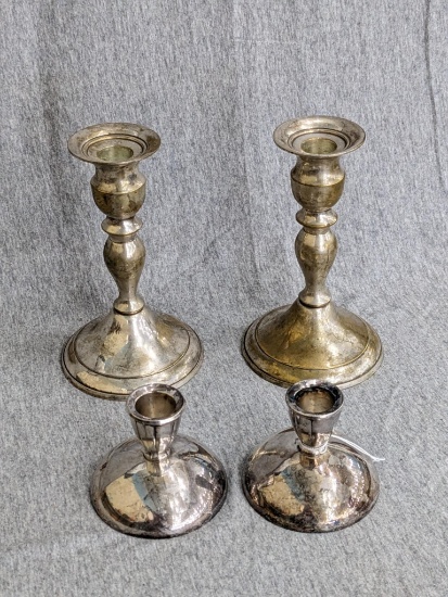 Two sets of silver plated candle holders; taller set measures 6-1/4" tall.