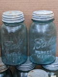 Nine quart blue Ball canning jars with zinc lids.