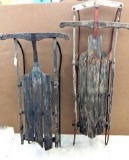 Two vintage runner sleds, both appear to be complete with some older repairs. The larger 48