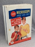 Vintage Gilbert microscope comes with box with original graphics. Microscope about 9