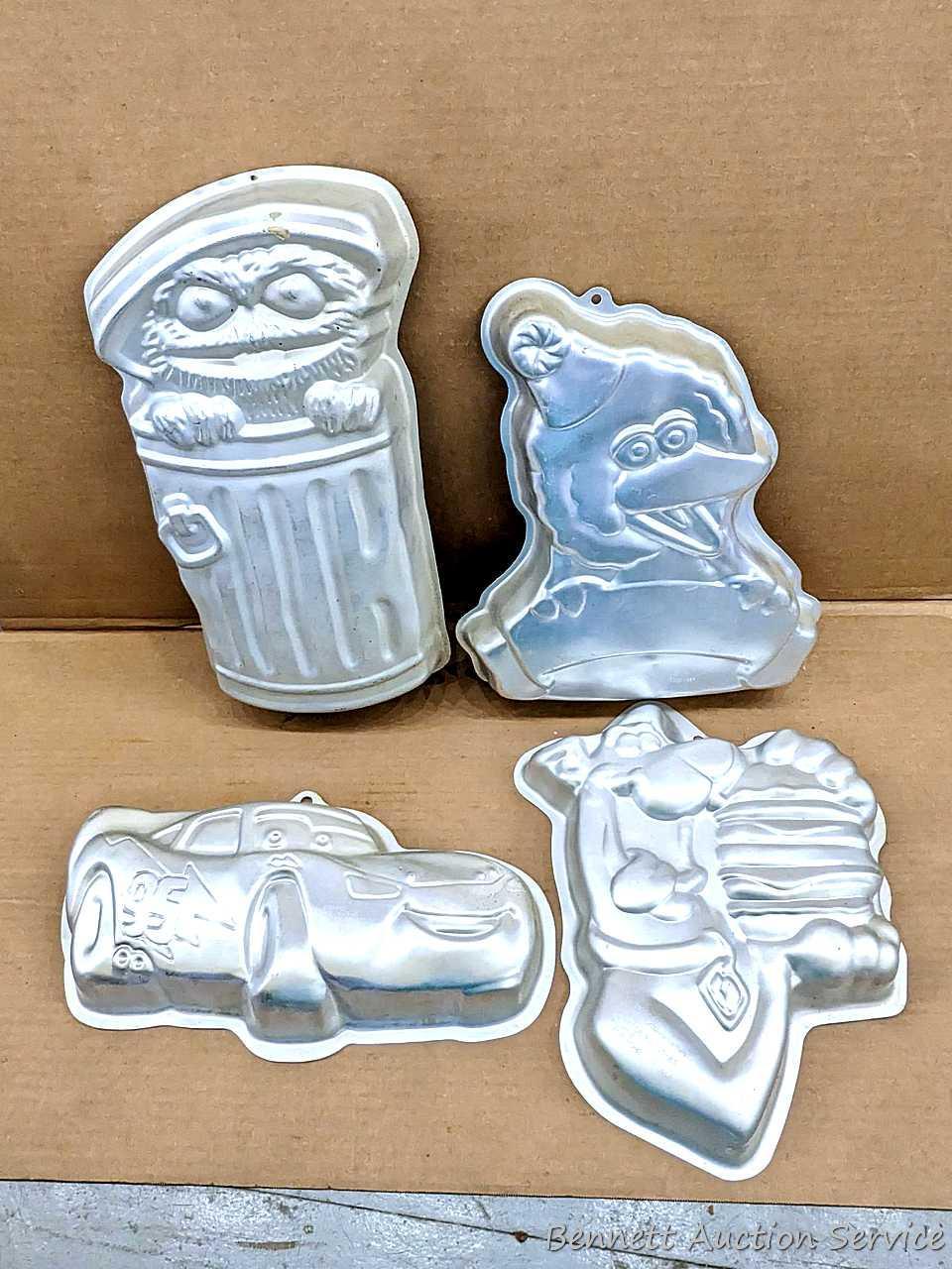 Four Wilton character cake pans including Oscar Proxibid