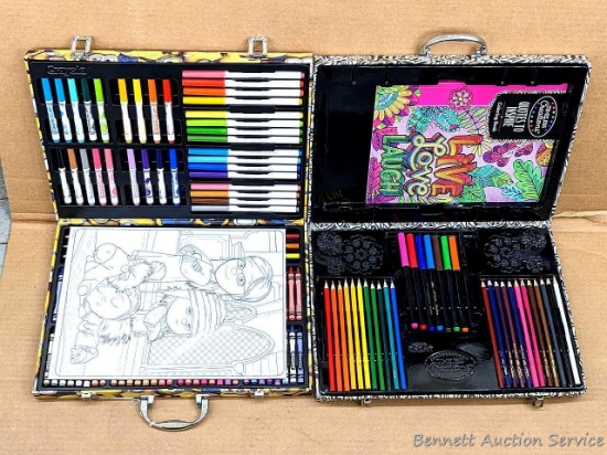 One Crayola art kit is complete and looks new; other art kit with new-looking pencils.