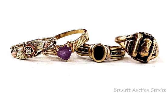 Four 10K gold rings incl one Black Hills Gold size 5. Purple one size 6-3/4 and marked 10K. Ring