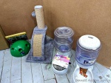 Pet supplies including cat scratching post, food and water dispensers, dishes, more.