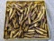 A hand and a half full of .22 LR ammunition by Winchester with hollow point bullets.