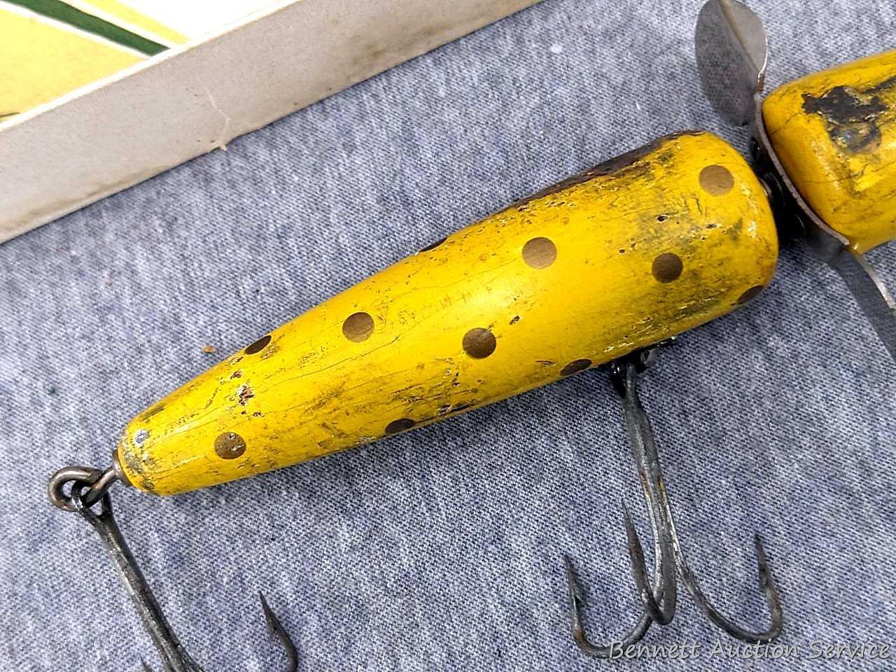 This old wood fishing lure is a Pflueger Globe and it comes with