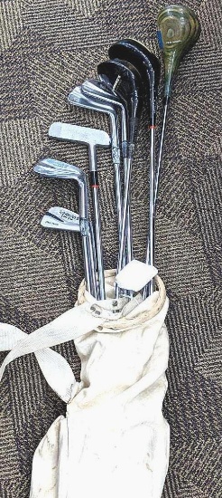 Several golf clubs incl. Spalding, Custom, Classic, woods, wedges, and a putter.