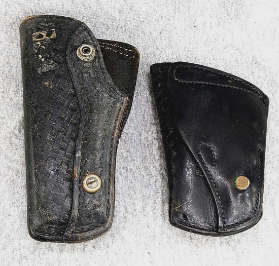 Two leather holsters, larger by Bucheimer Clark and marked Combat B13A-14W LH. Larger measures 7"
