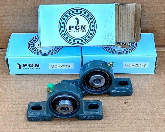 Set of four PGN greaseable pillow block bearings. The bearings appear to be new and have a 1/2"