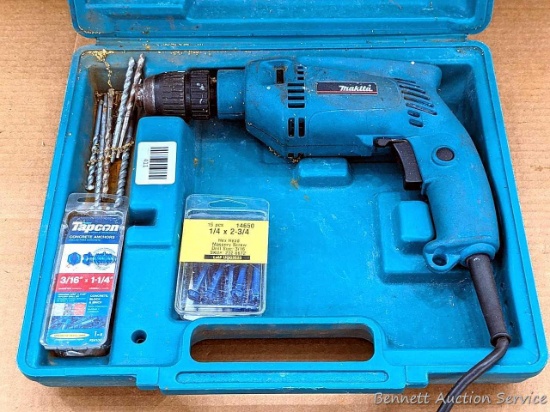 Makita corded drill, 115 volts with some bits, anchors and masonry screws. Runs but smells a little