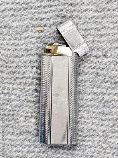 Unique Dana Zippo lighter is rather heavy and measures about 2-3/4" tall. No spark but may be easy
