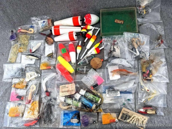 Assortment of bobbers, twirl tail lures, small spoon baits, and more as pictured.