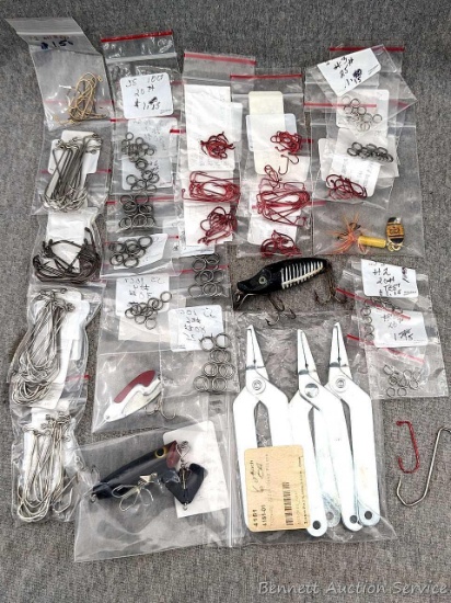 Assortment of fish hooks in various sizes, sputter buzz lure, spook sinker lure, split ring pliers