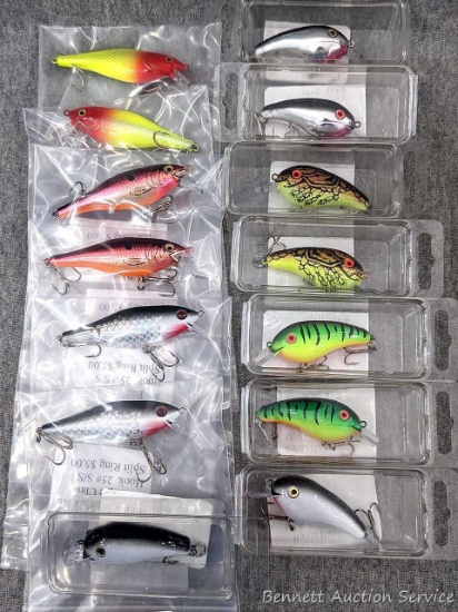 14 hard fishing lures, some or all rattle. Longer about 3" over body and tongue.