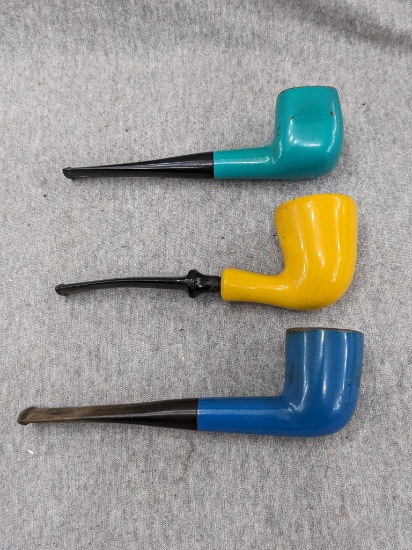 Trio of tobacco smoking pipes in complementary colors. Yellow "The Smoke" measures 5-1/2" long, blue