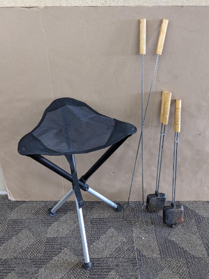 2 Pudgy pie makers, marshmallow and hot dog sticks, and a tripod seat with extendable legs. Seat