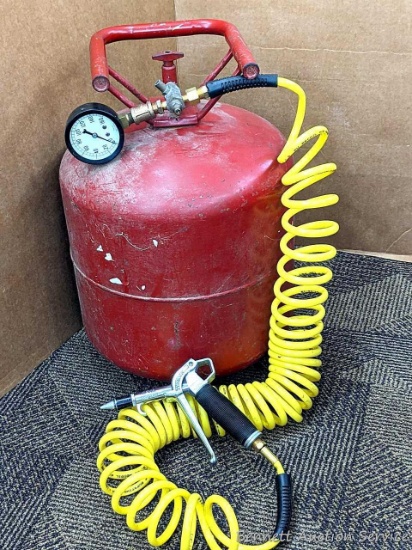 Portable air tank stands 18" tall and comes with a length of hose and a blower fitting.