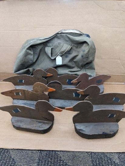 Vintage duck decoys in a 20" canvas bag. Seller notes the decoys are from the 1950's. Measure about