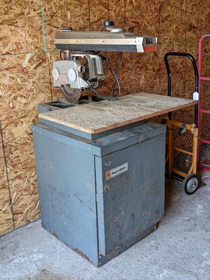 DeWalt 740 Powershop 10" radial arm saw on Black & Decker cabinet. Has 2 hp motor and manual brake.