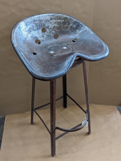 Well made shop stool with tractor seat is in good sturdy condition and measures about 34" x 19" x