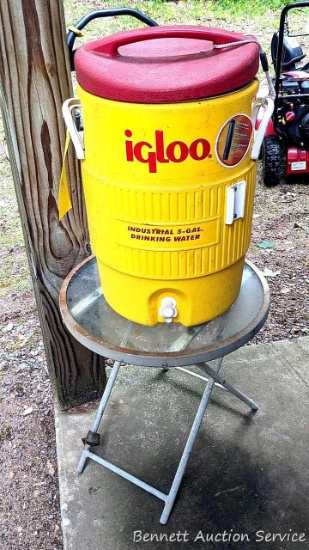Igloo Industrial 5-gal drinking water measures approx 21" tall; small white circular outdoor folding