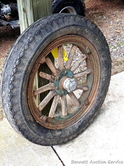 Overland wooden spoked rim Good Year tire measures 30" tall. Very cool decoration for the garden or