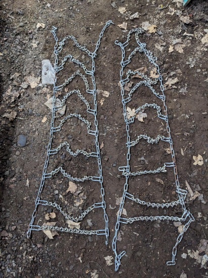 Pair of tire chains are unused or barely used. 60" long x 16" wide.