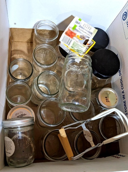 Pint and quart large mouth canning jars with a box and a half of lids and 3 glass canisters.