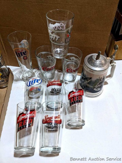 Pint sized beer glasses including Miller Lite, Coors, Leinenkugel's and a beer stein with wolves on