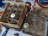 Seven quart canning jars, plus several smaller jars.