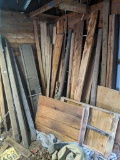 Nice collection of wood including wooden fence posts, shutter or two, some plywood, more.