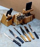 Three knife blocks filled with knives.