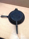 Griswold cast iron American No. 9 waffle iron with stove ring. Waffle iron measures 17