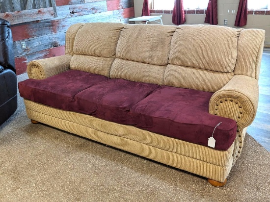 7' wide sofa is in overall good condition with a cover over seat cushions.