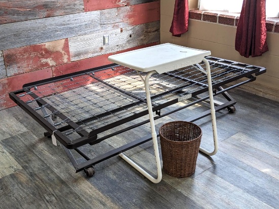 Trundle bed frame fits a twin mattress; wicker wastebasket and an adjustable TV-style tray.