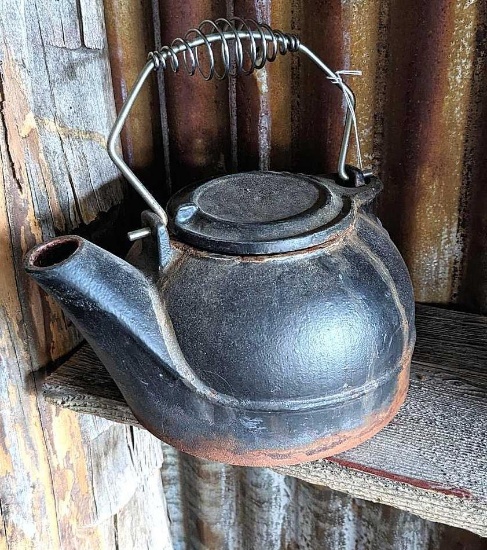 Cast iron tea kettle style humifier for wood stoves. Measures approx. 6" x 10" across spout without