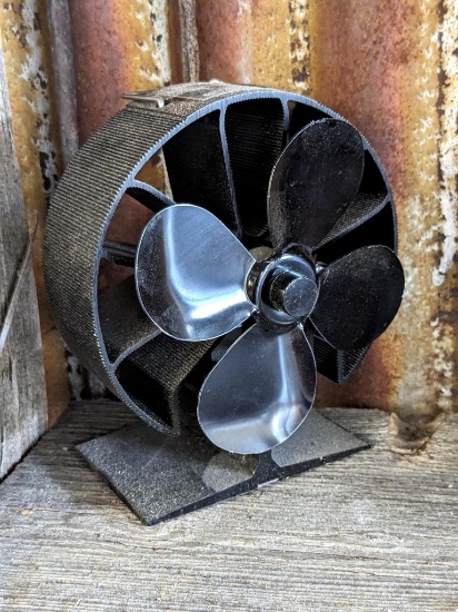 Stove fan is powered by the stove's heat, stands approx. 7" overall.