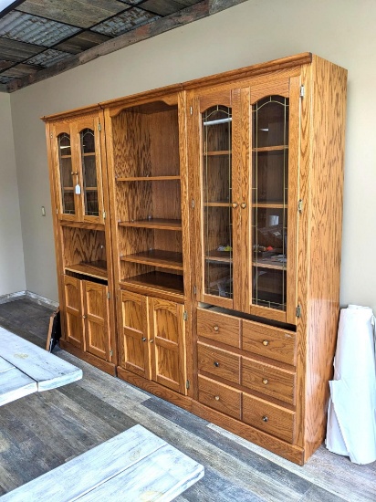 Four section shelf unit set is in overall good condition. One door and two pieces of trim noted