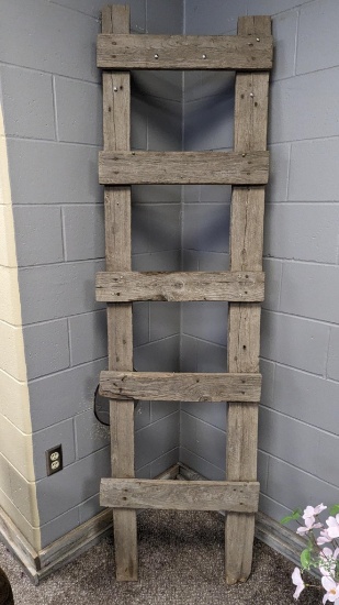 Rustic wooden ladder stands nearly 7' tall and is approx. 2' wide.