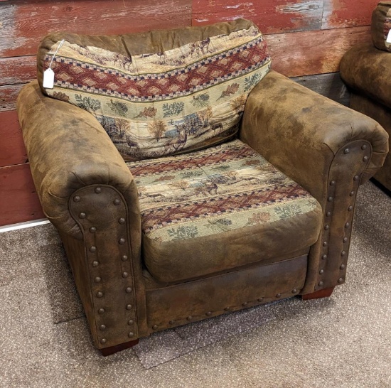 Northwoods themed armchair is in fair condition and measures approx. 46" over arms. Matches Lot 1