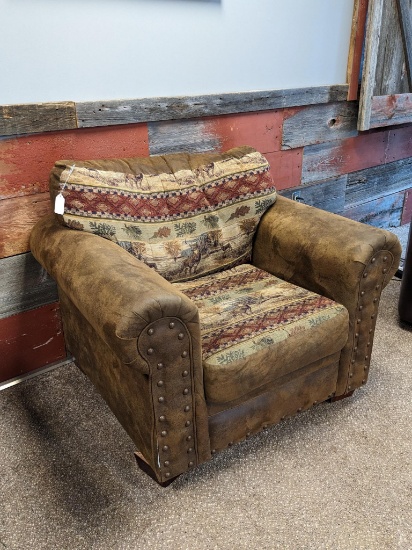 Northwoods themed armchair is in fair condition and measures approx. 46" over arms. Matches Lot 3