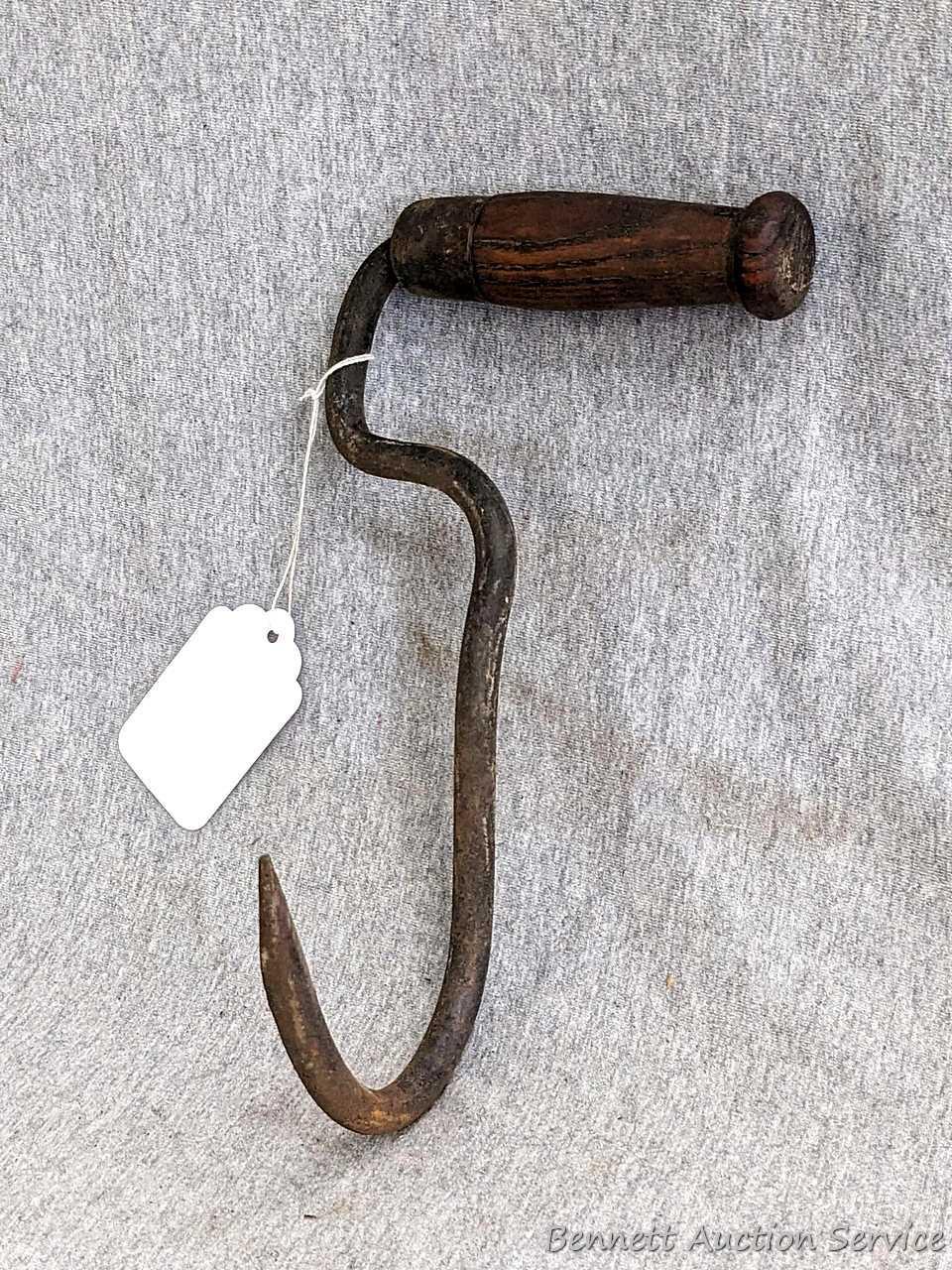 Antique hay hook with nice wooden handle is about